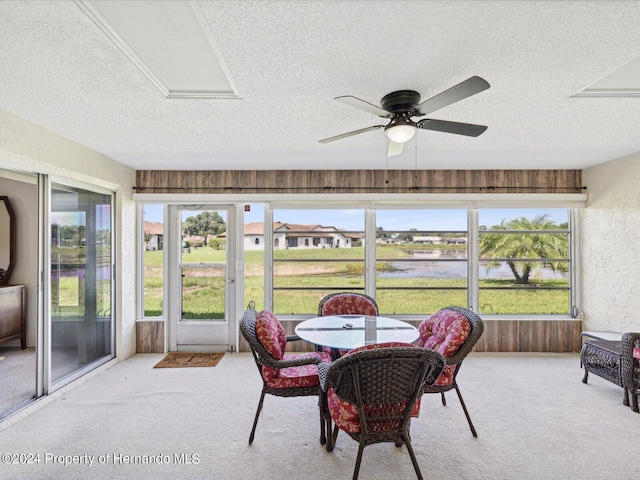 sunroom / solarium featuring ceiling fan and plenty of natural light