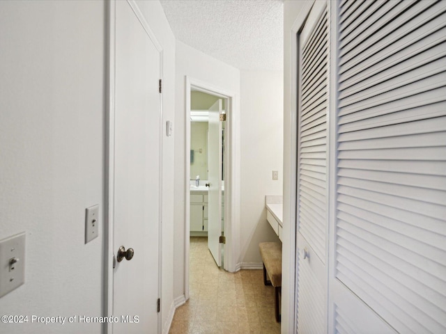 corridor with a textured ceiling