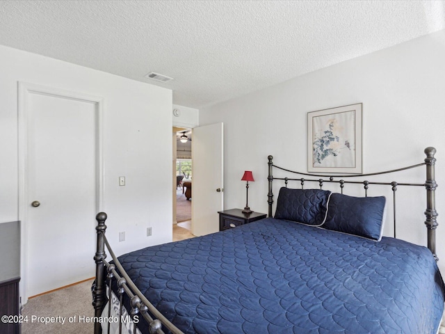 carpeted bedroom with a textured ceiling