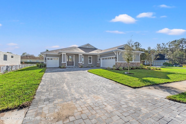 view of front of house featuring a garage and a front lawn