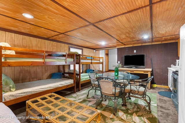 bedroom featuring wooden walls and wooden ceiling