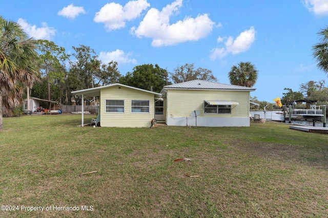 back of property with a lawn