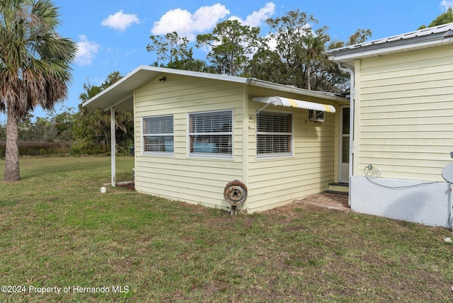 view of side of home with a lawn