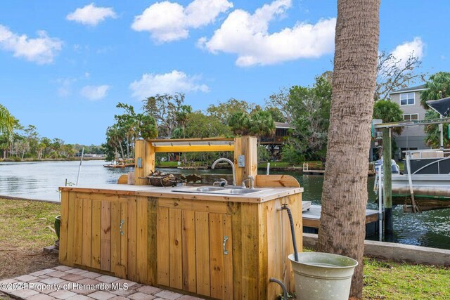 dock area with a water view and sink