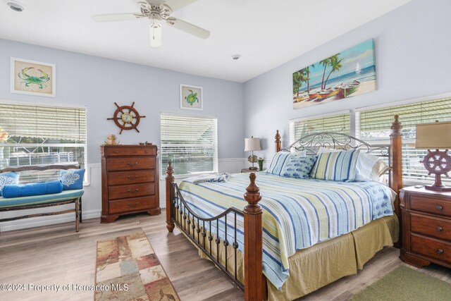 bedroom with ceiling fan and light hardwood / wood-style floors