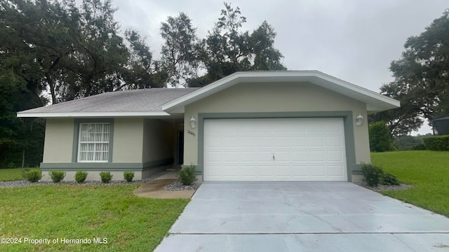 ranch-style home with a front lawn and a garage