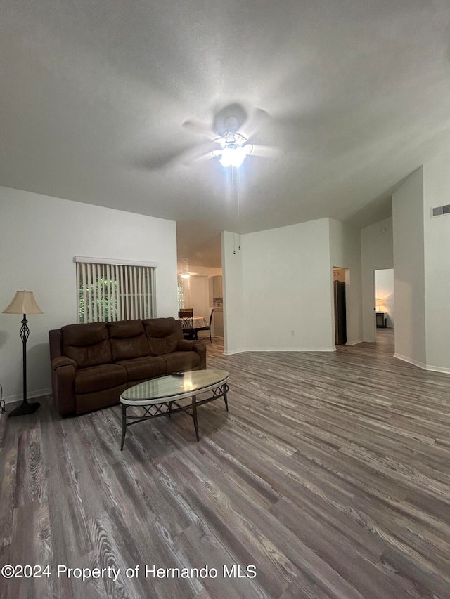 living room with vaulted ceiling, ceiling fan, and dark hardwood / wood-style flooring