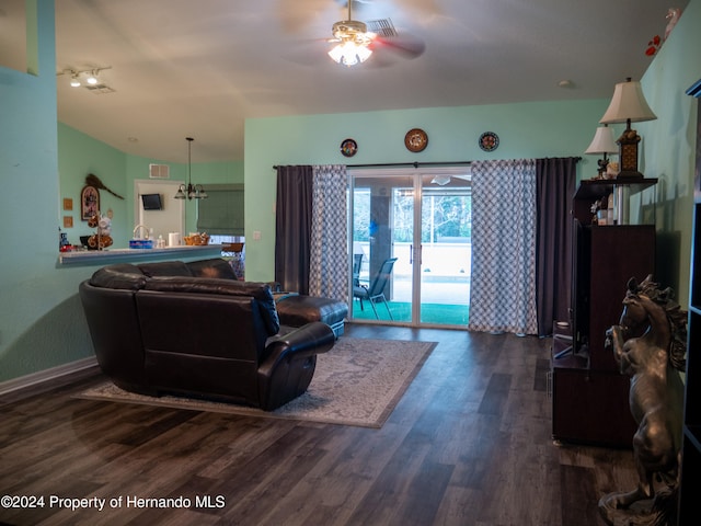 living room with hardwood / wood-style floors and ceiling fan with notable chandelier