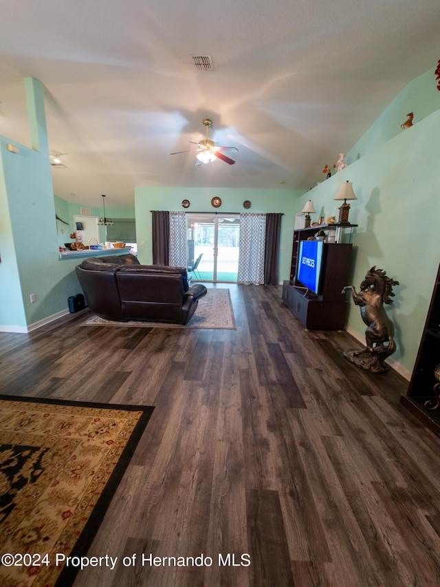 living room with ceiling fan, dark wood-type flooring, and vaulted ceiling