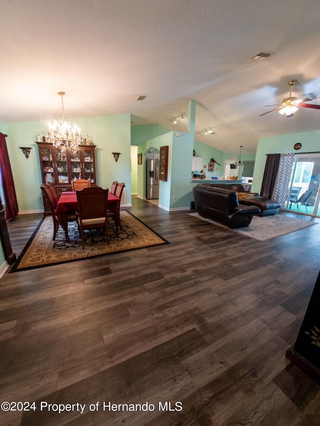 dining area featuring ceiling fan with notable chandelier and dark hardwood / wood-style floors