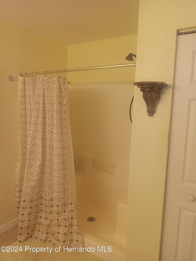 bathroom featuring tile patterned flooring and walk in shower