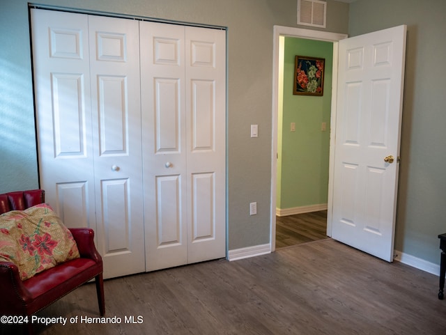 sitting room with wood-type flooring