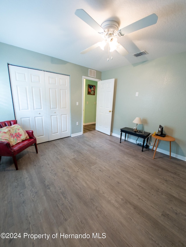 interior space with ceiling fan and dark hardwood / wood-style floors