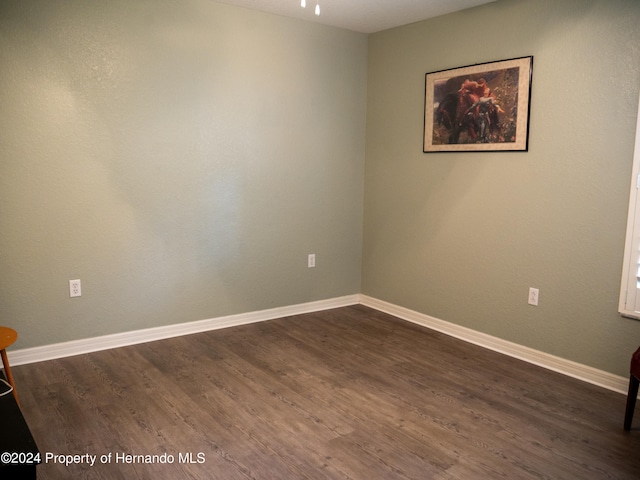 spare room with dark wood-type flooring