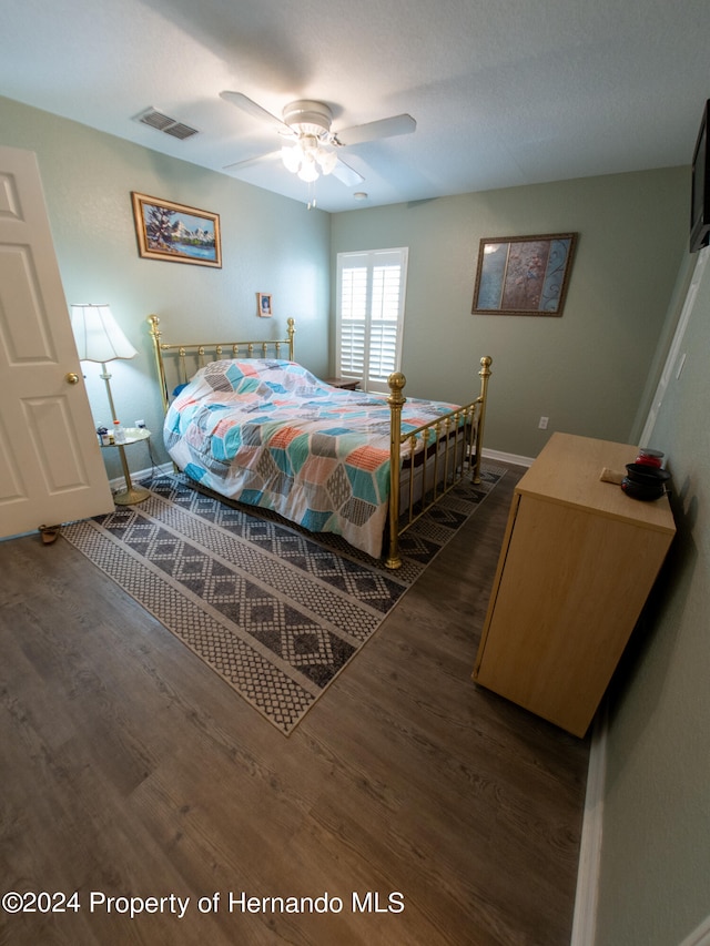 bedroom featuring dark hardwood / wood-style flooring and ceiling fan