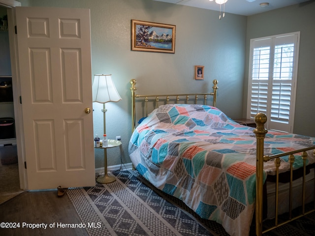 bedroom with hardwood / wood-style flooring