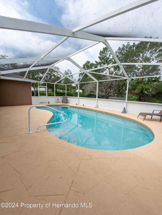 view of pool featuring a lanai and a patio area