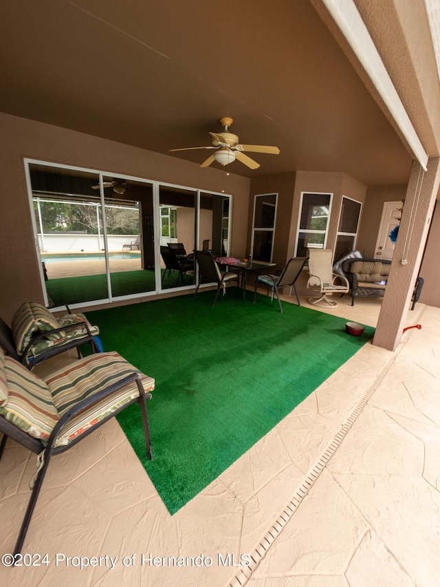 exterior space featuring a lawn, ceiling fan, and a patio area