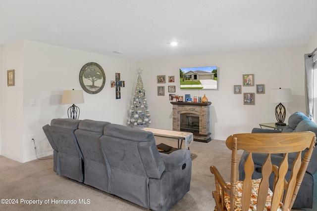 living room featuring a stone fireplace and light colored carpet