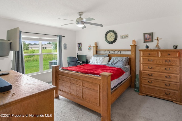 carpeted bedroom with a textured ceiling and ceiling fan