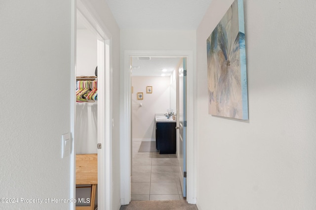 hall featuring light tile patterned floors