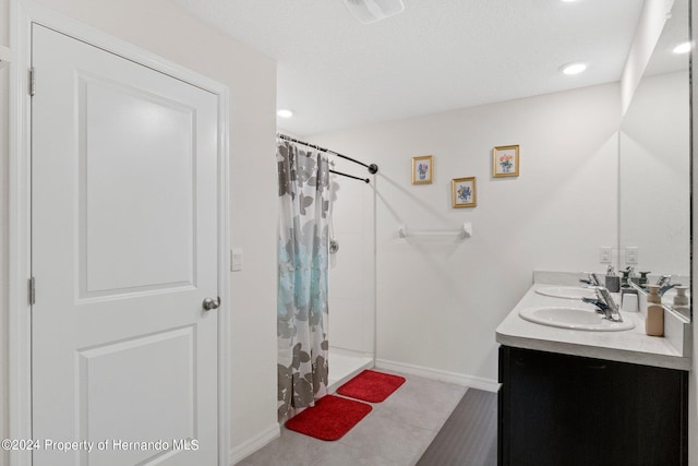 bathroom with tile patterned flooring, curtained shower, and vanity