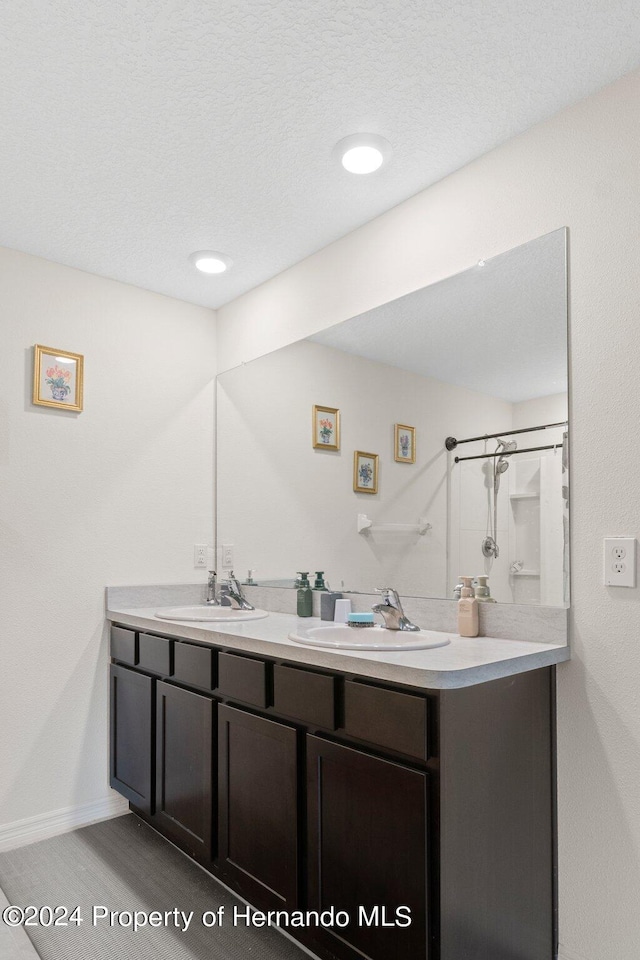 bathroom featuring walk in shower, vanity, and wood-type flooring