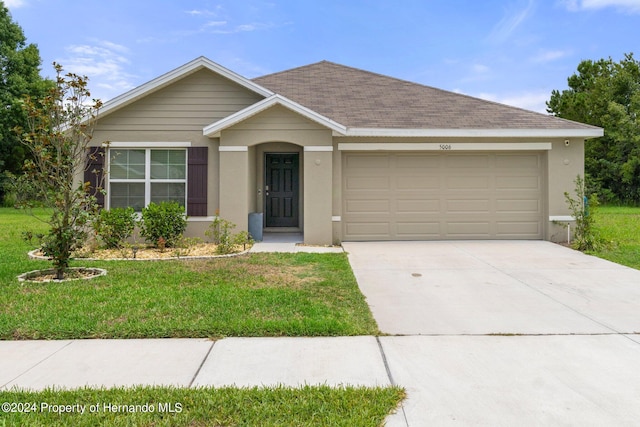 single story home with a front lawn and a garage