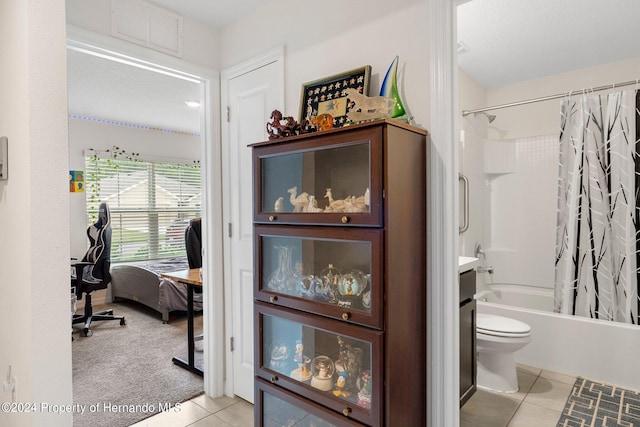 interior space featuring toilet, shower / bath combo, and tile patterned flooring