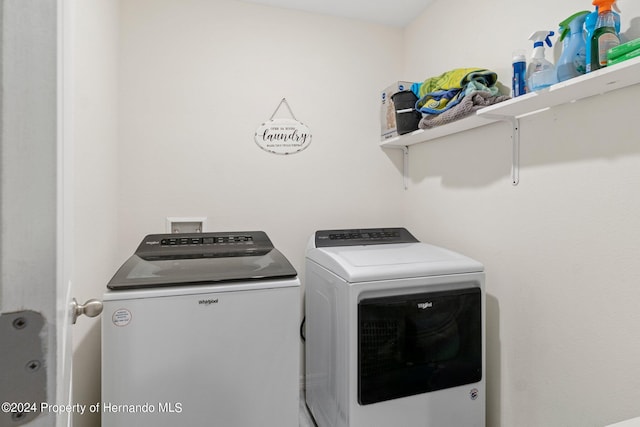 clothes washing area with separate washer and dryer