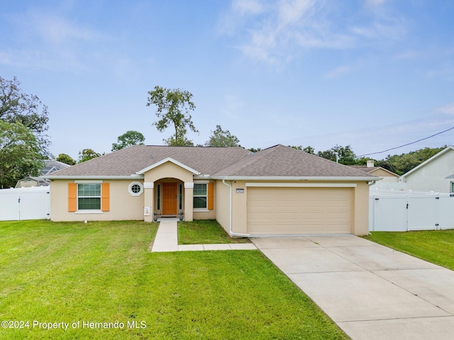 ranch-style house featuring a front yard and a garage