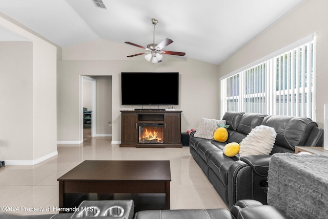 living room with ceiling fan, light tile patterned floors, and vaulted ceiling