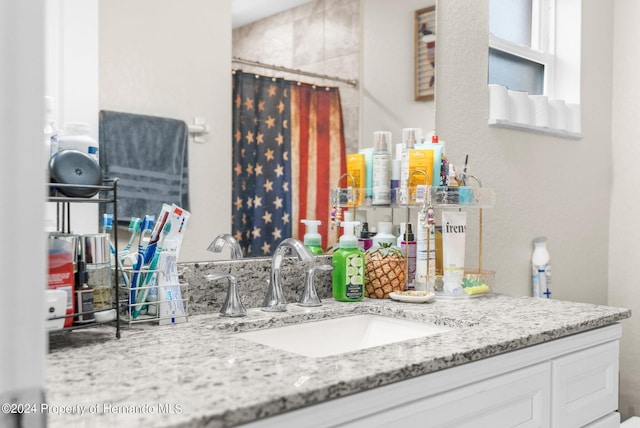 bathroom featuring vanity and curtained shower