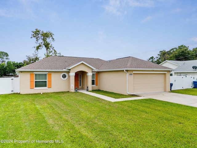 single story home featuring a garage and a front yard