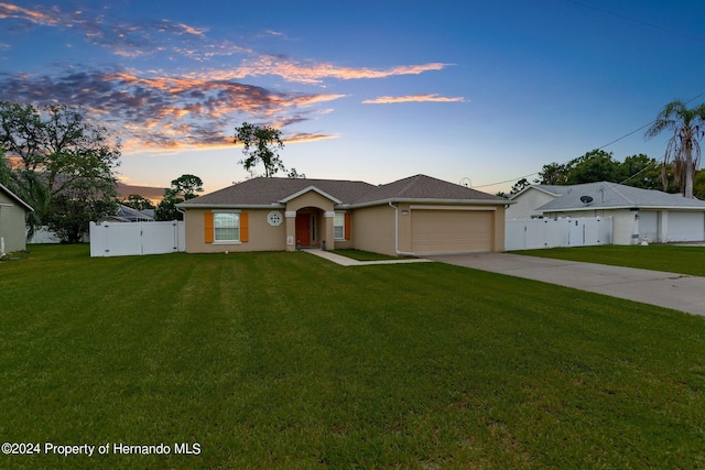 single story home with a garage and a lawn