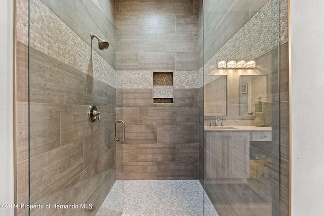 bathroom featuring sink and an enclosed shower