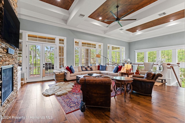 living room featuring a towering ceiling, hardwood / wood-style floors, and a fireplace