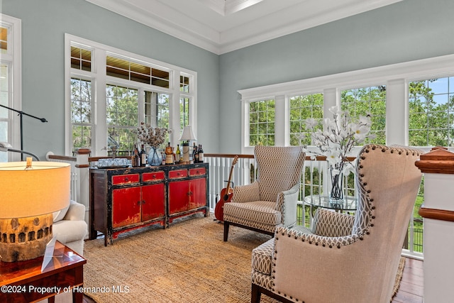 living area featuring ornamental molding and light hardwood / wood-style flooring