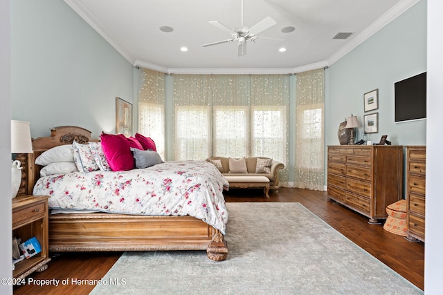 bedroom featuring dark wood-type flooring, ceiling fan, and ornamental molding