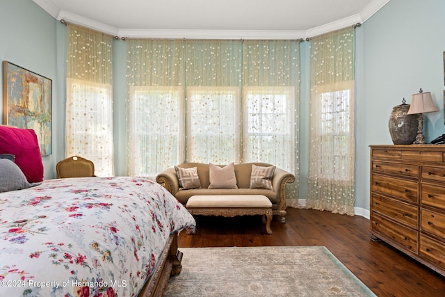 bedroom with dark hardwood / wood-style floors and crown molding