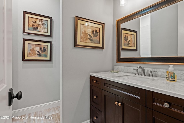 bathroom featuring vanity and hardwood / wood-style floors