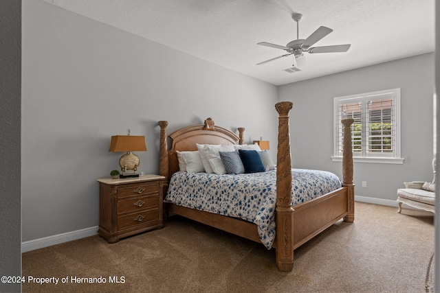 carpeted bedroom featuring a textured ceiling and ceiling fan