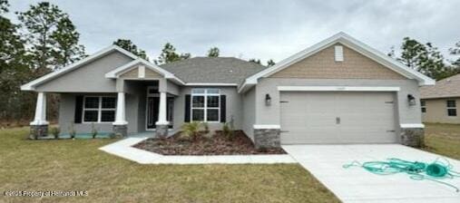 craftsman house with a front lawn and a garage