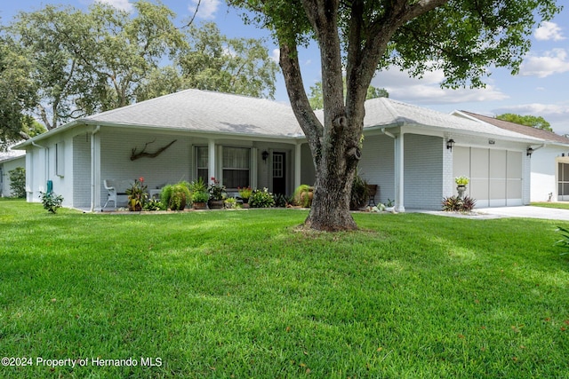 ranch-style house featuring a garage and a front yard