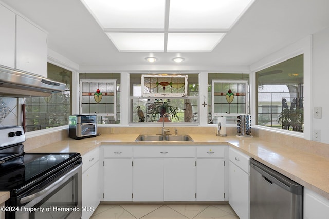 kitchen with black electric range oven, light tile patterned floors, sink, white cabinets, and stainless steel dishwasher