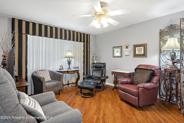 living room featuring hardwood / wood-style floors and ceiling fan