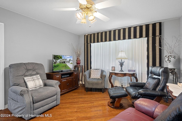 living room featuring ceiling fan and light wood-type flooring