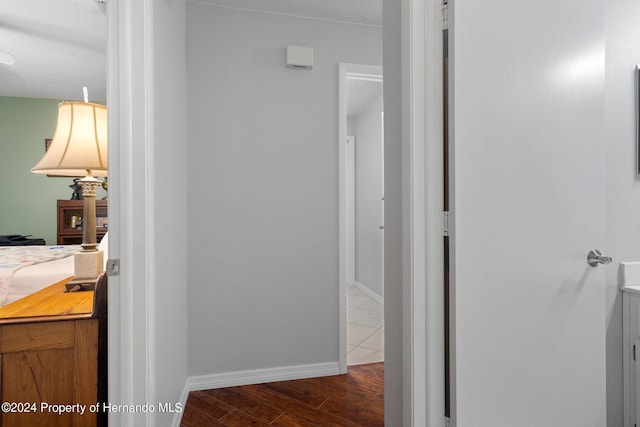 bathroom featuring wood-type flooring and a textured ceiling