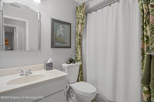 bathroom featuring toilet and vanity