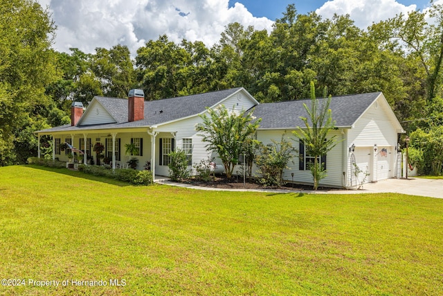 view of front of property with a garage, a front yard, and a porch